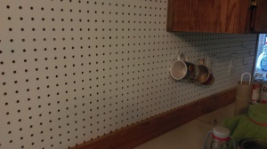 My cool new kitchen back splash! It's so fun that I can move hooks around to hang stuff. 